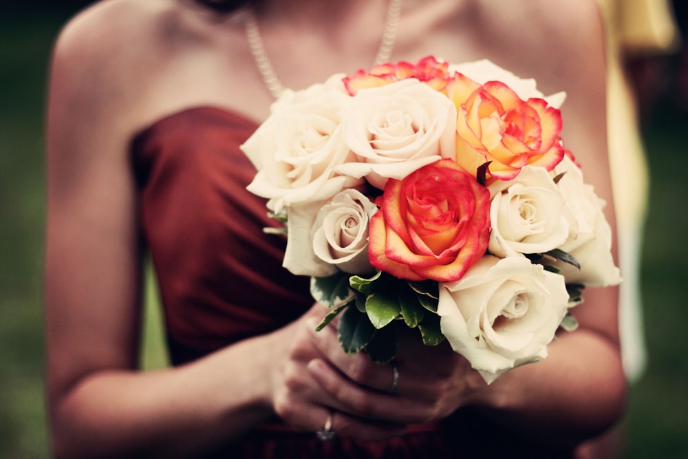 woman holding bouquet of flowers