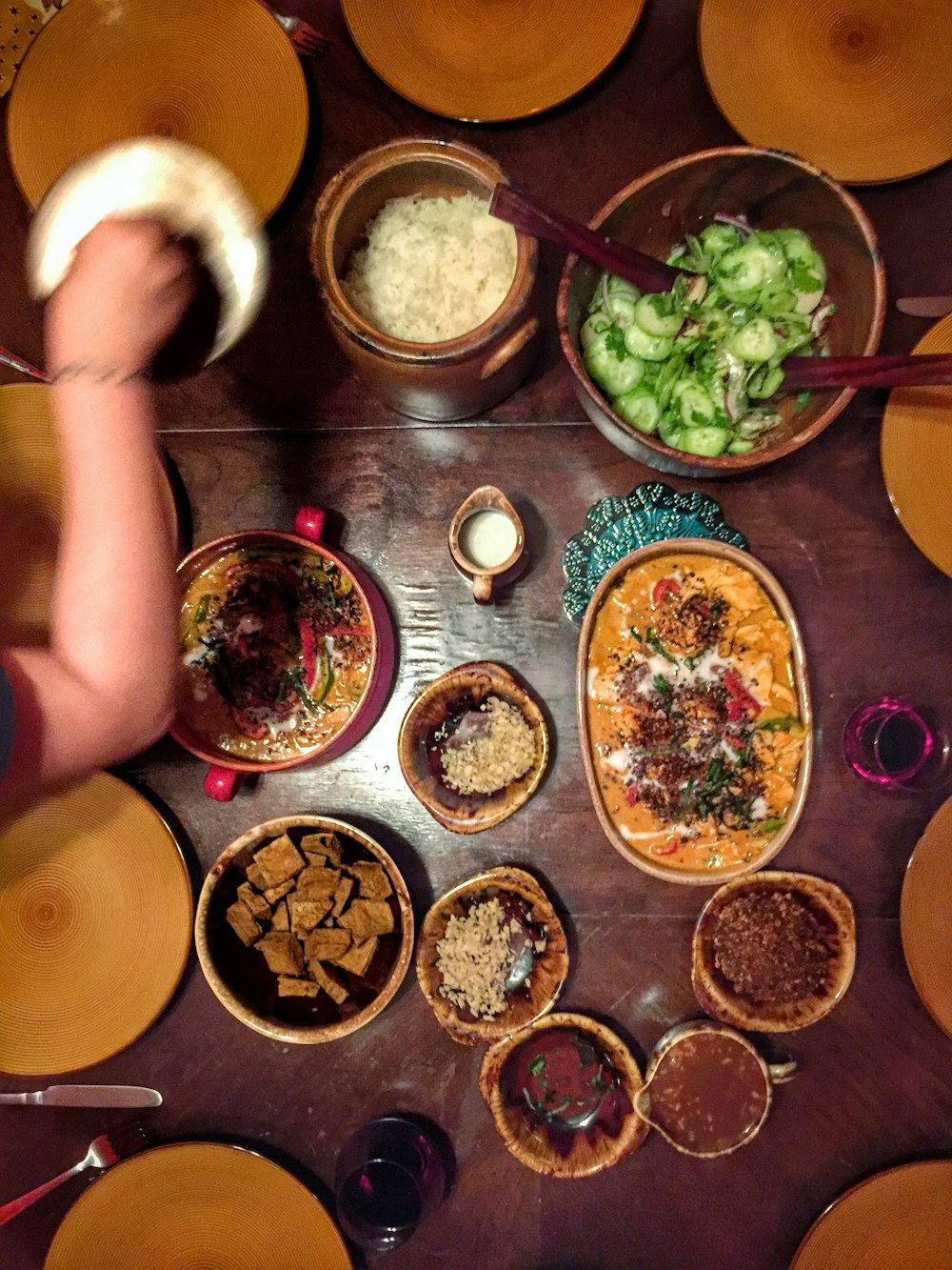 person sitting on chair in front of table with foods