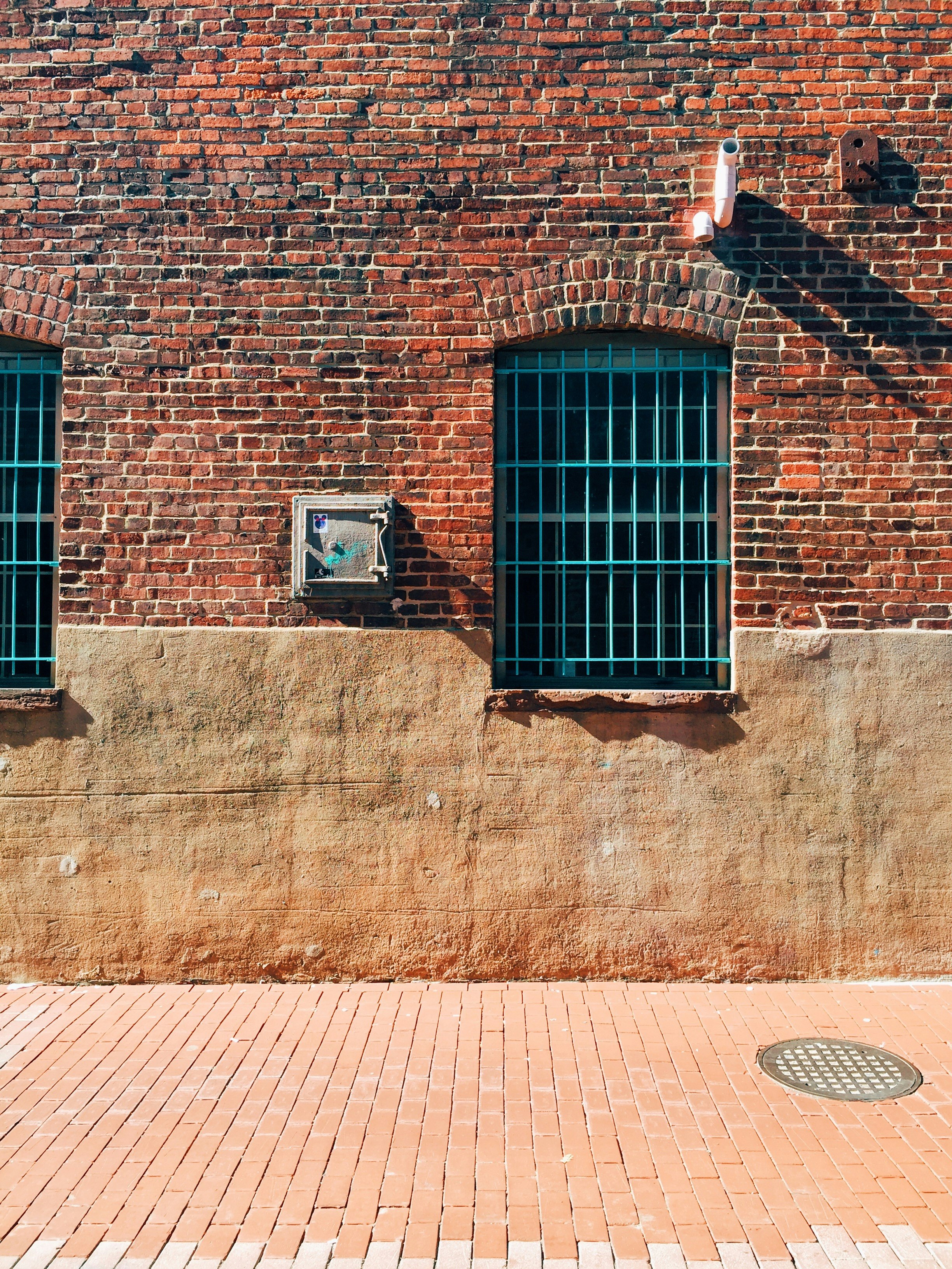 black metal window on brown brick wall