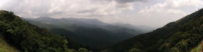 Panoramic view of rolling mountains and dense forests from the retreat’s hillside.