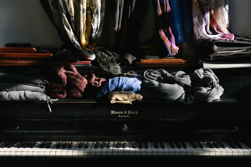 assorted clothes on top of piano