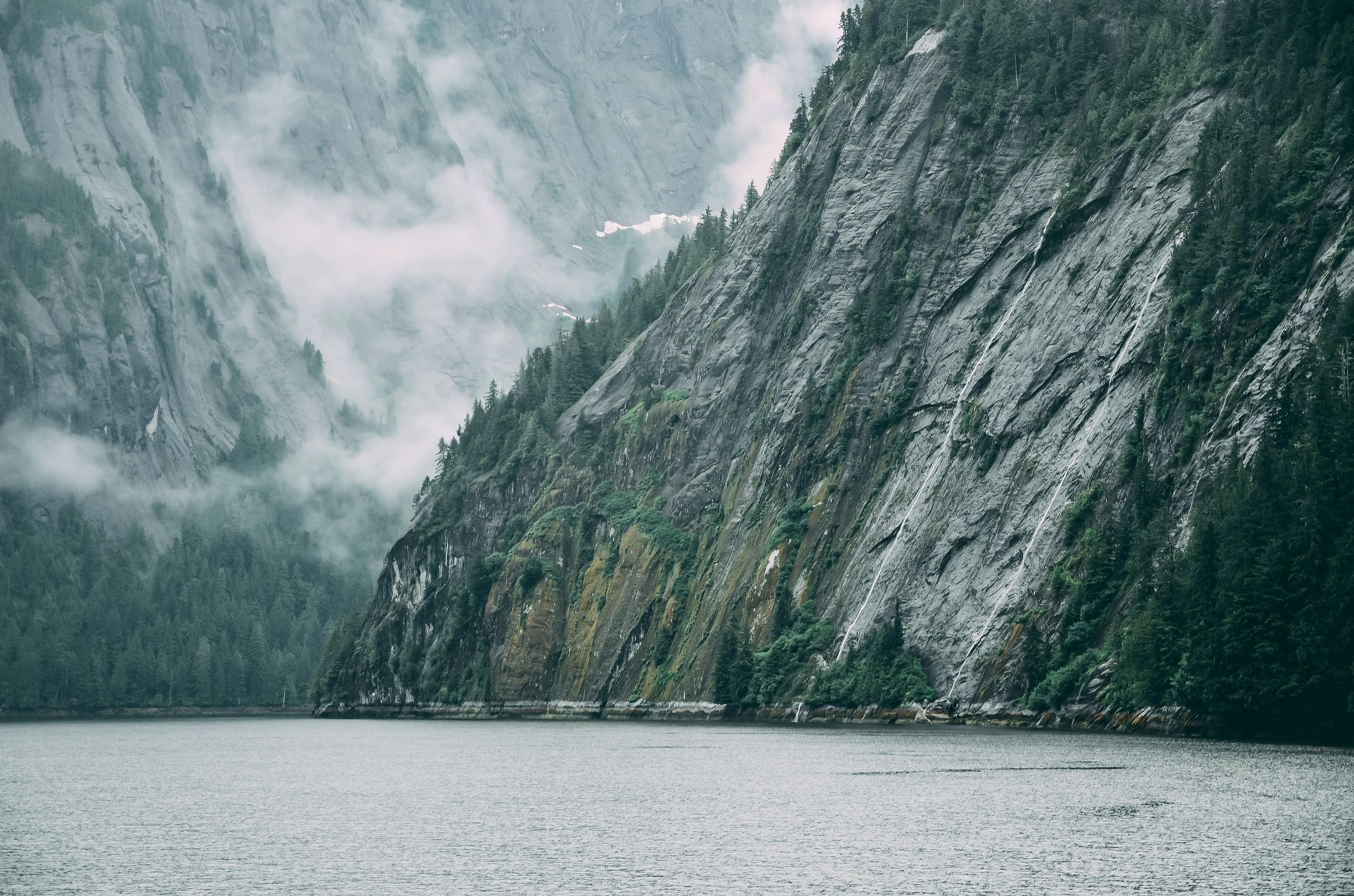 grey rock cliff near body of water, Alaskan Mountainscape