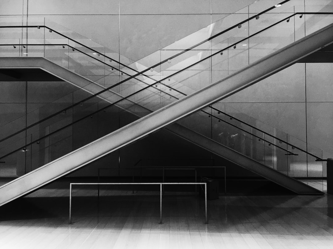 grayscale photo of glass stairs