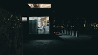 Business storefront equipped with advanced alarm systems and automated gates under bright daylight.