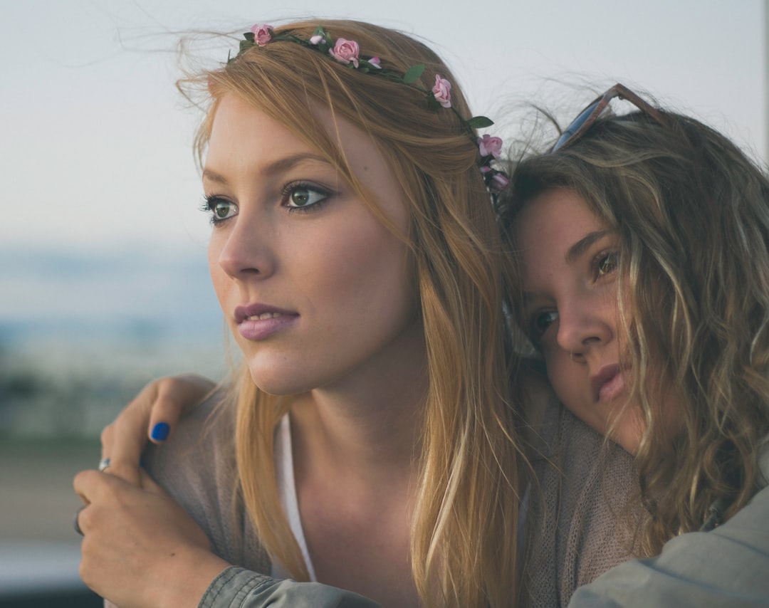 two women close up photography