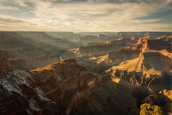 grand canyon below cloudy sky