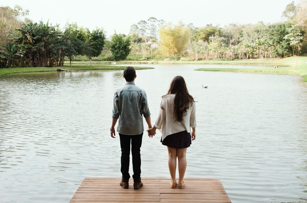 man and woman standing on dock