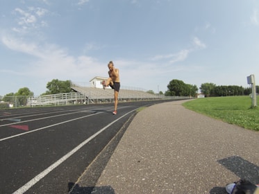 Back brace worn by a runner stretching before a morning jog.