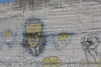 Portrait of Carlos Fonseca in a historical setting with revolutionary symbols.