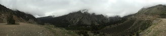 A panoramic view of a misty mountain range covered in dense Atlantic Forest.
