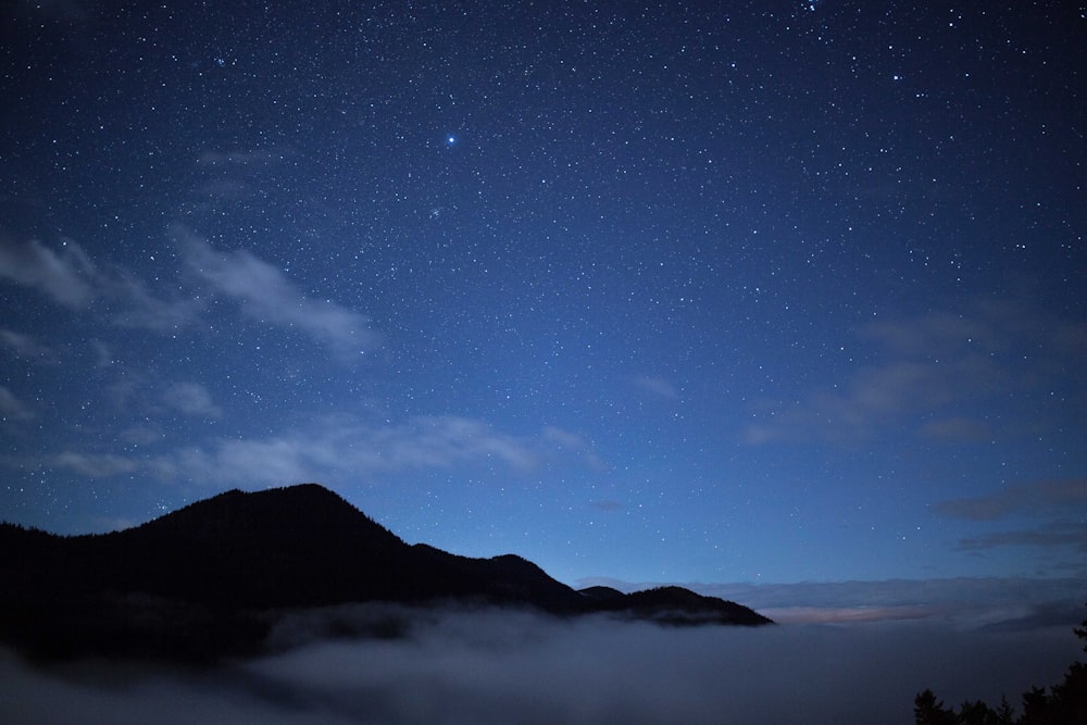 mountain and clouds during nighttime