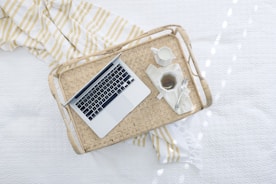 gray laptop computer on beige wicker chair