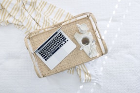 gray laptop computer on beige wicker chair
