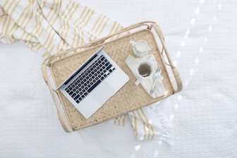 gray laptop computer on beige wicker chair