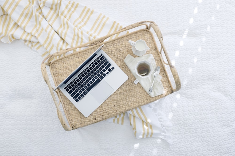 gray laptop computer on beige wicker chair