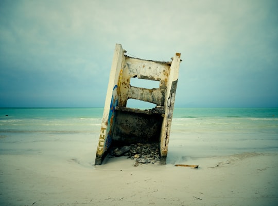 white steel frame near beach shore during daytime in Holbox Mexico