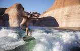 man riding surfboard during daytime