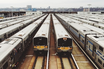 white train lot on railway during day time