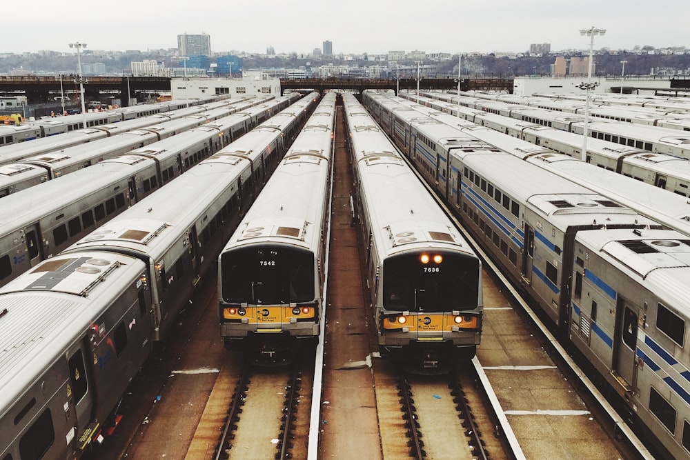 white train lot on railway during day time