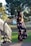 A stylish woman wearing a flowing summer dress in a sunny park.