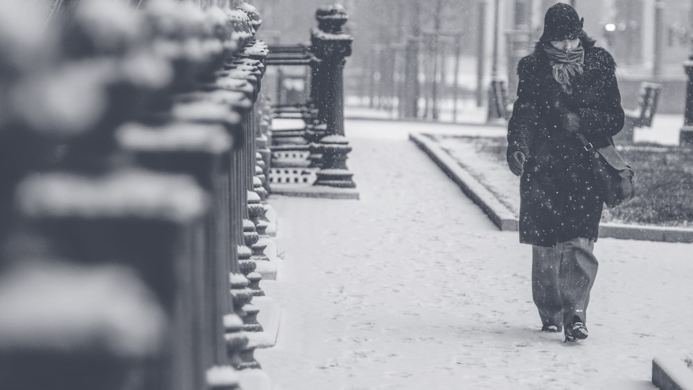 grayscale photo of person walking on street