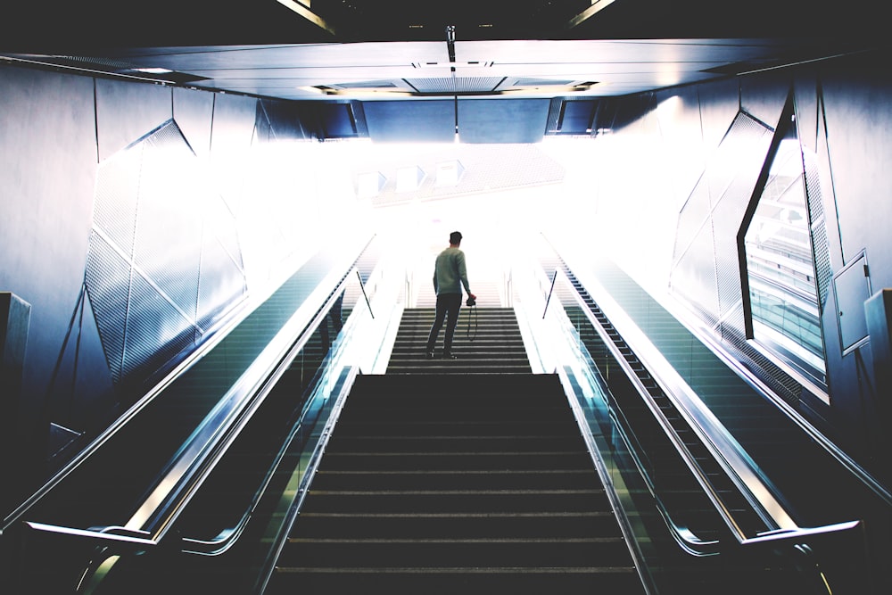 man standing on escalator