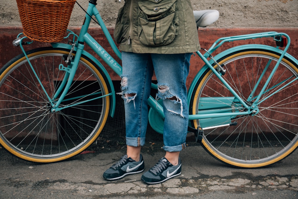 person standing beside bike