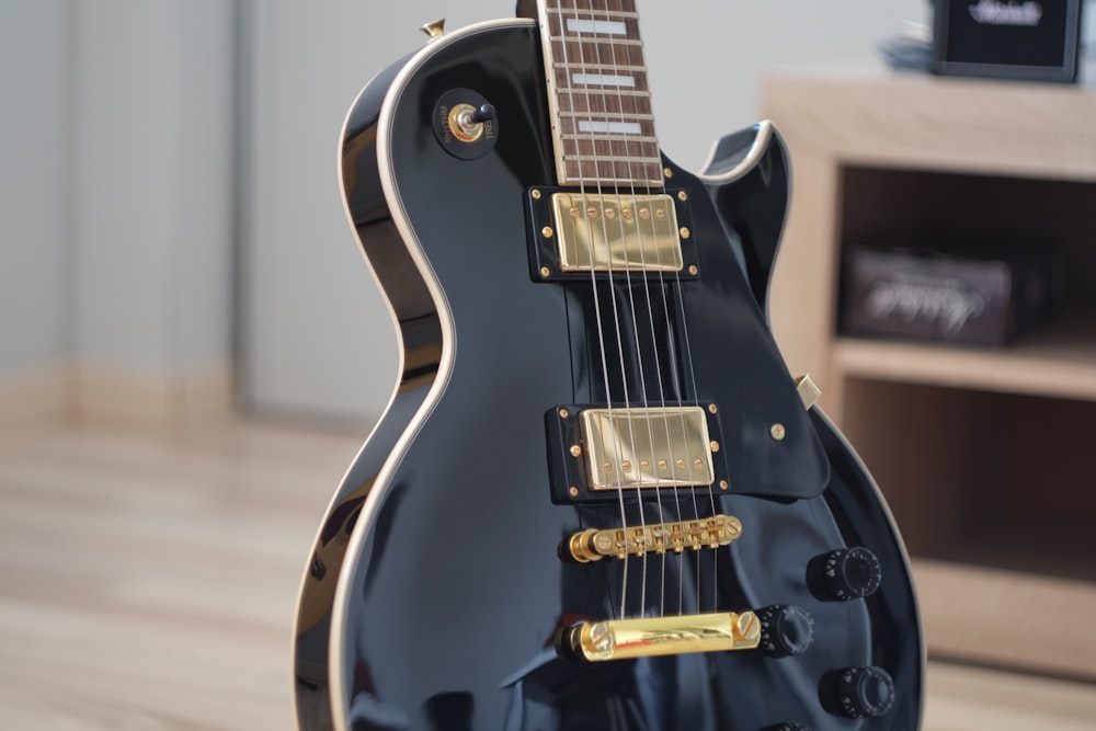macro shot photo of black electric guitar