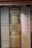 A row of vintage hardcover books with visible spines. Titles include 'Yankee Priest' by Edward F. Murphy, 'Basic History of the United States' by Charles A. and Mary R. Beard, and 'Three Detective Novels' by John Dickson Carr. The books are neatly arranged and display a variety of muted colors and classic typography.