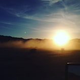 A mystical sunset over a mountain range, symbolizing spiritual journeys and transformation.