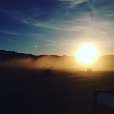 A mystical sunset over a mountain range, symbolizing spiritual journeys and transformation.