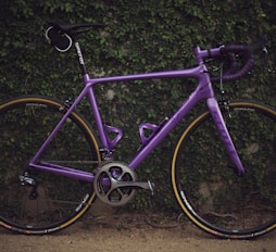 purple road bike near wall