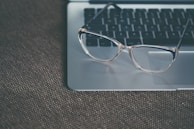 clear eyeglasses with black frames on laptop