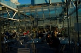 Outdoor restaurant seating area enclosed with transparent automatic glass walls.