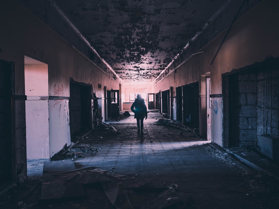 person walking on hallway of building, Detroit building at night