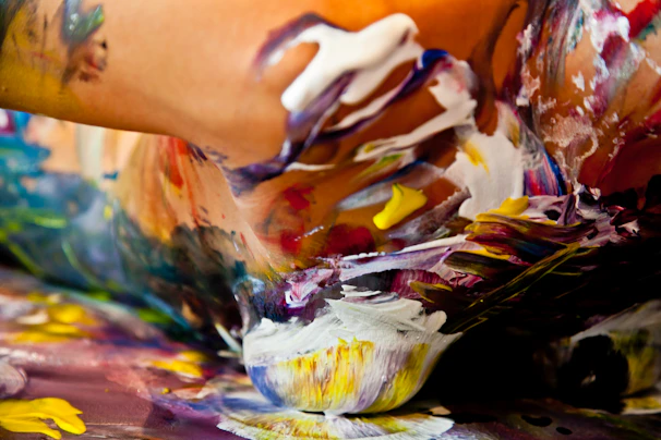 Close-up of a delicate body paint design with soft pastel colors and fine brush strokes on an arm.