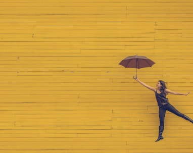 woman holding brown umbrella