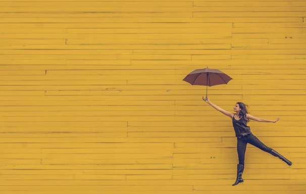 woman holding brown umbrella