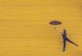 woman holding brown umbrella