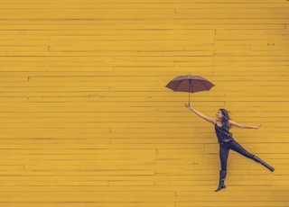 woman holding brown umbrella