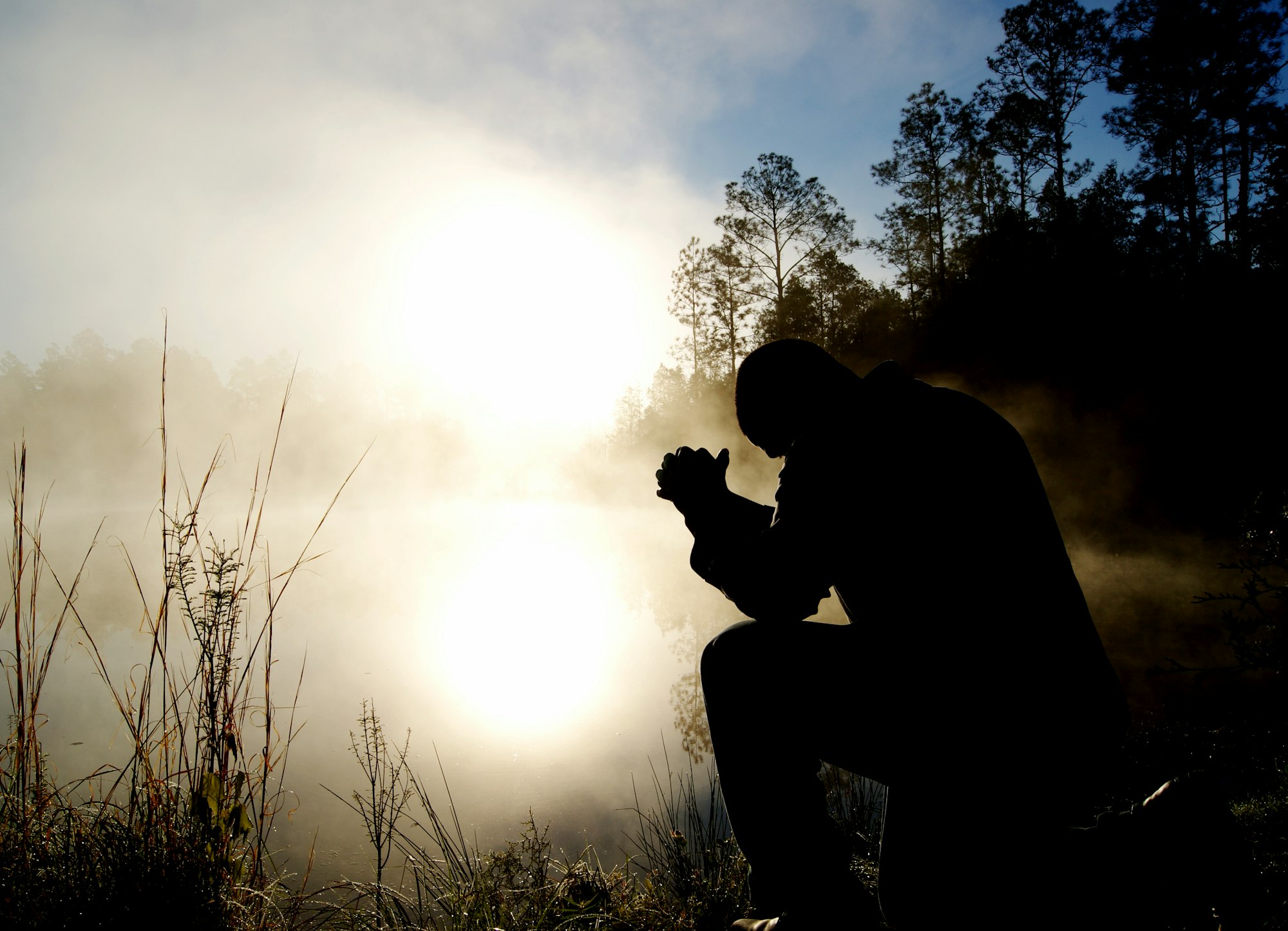 Silhouette man praying