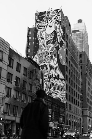 A finished mural displayed proudly in a lively urban setting.