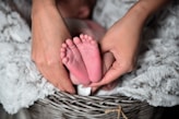 person holding baby's feet