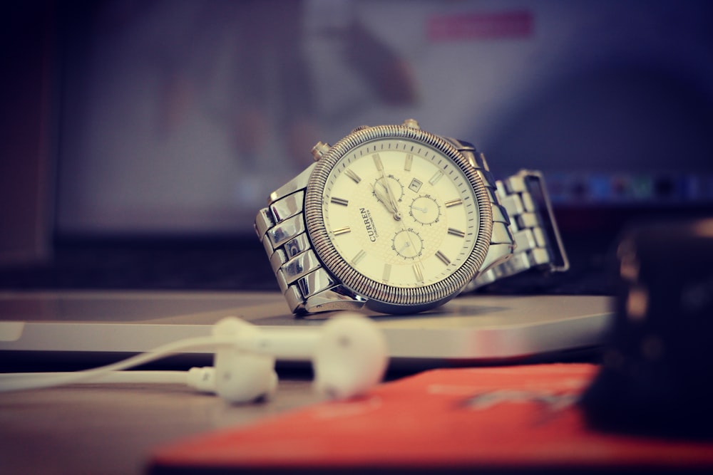 round silver-colored analog watch with link bracelet