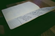 Open journal showing a trigger mapping page with neat handwriting and soft shadows.