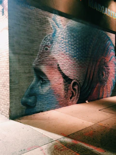 An artist painting a large mural that blends storytelling with bold visual art.