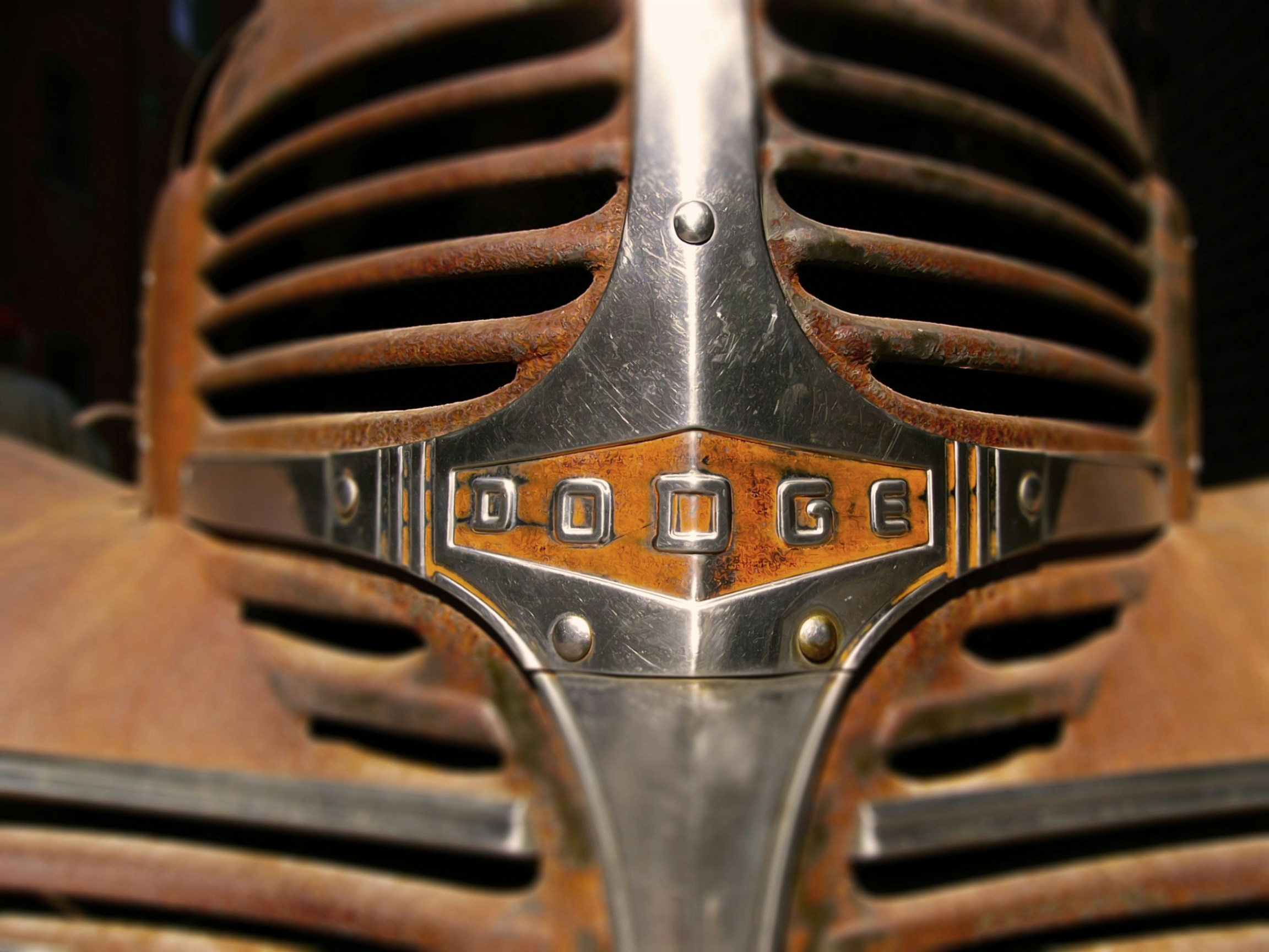 Rusty chrome grille of old dodge car.