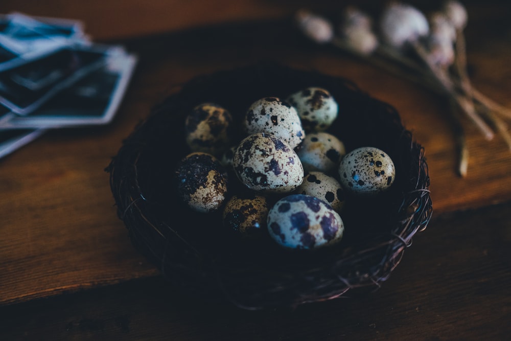 quail eggs on nest on wooden surface