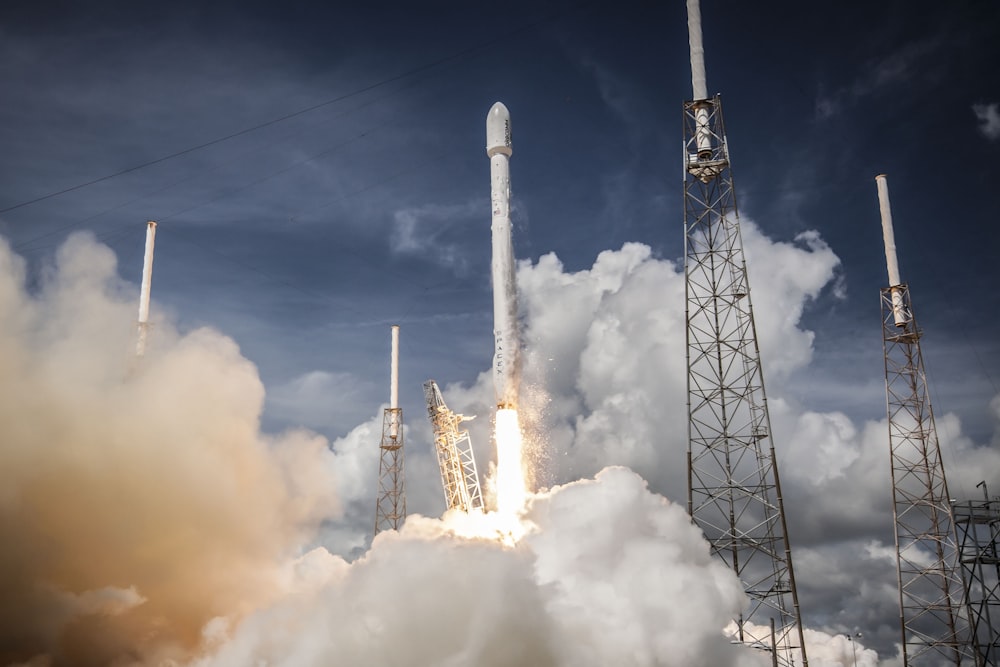 rocket launching with white smoke underneath