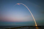 rocket launch light trail at dusk